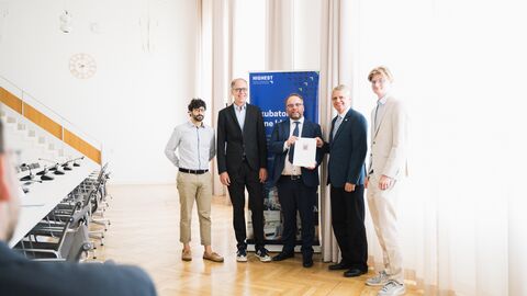 Wissenschaftsminister Timon Gremmels überreicht den Förderbescheid an das "Innoboost"-Team der TU Darmstadt.